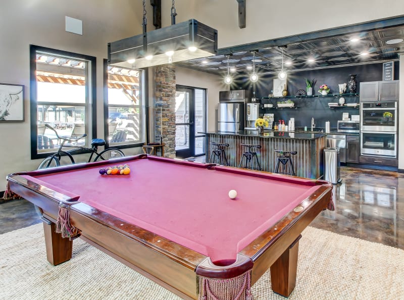 Pool table and clubhouse kitchen Timnath Trail at Riverbend Apartment Homes in Timnath, Colorado